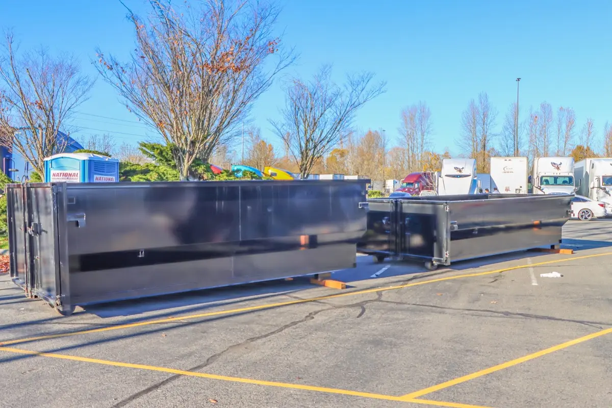 Professional dumpster rental service with roll-off container on residential driveway in Sturgis